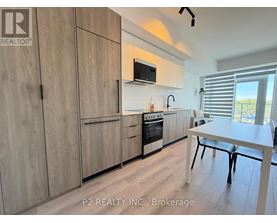 A kitchen with wooden cabinets and a white table.
