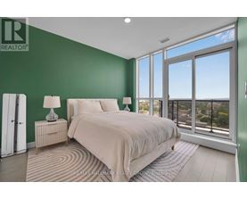 A bedroom with a large bed and a view of the city.