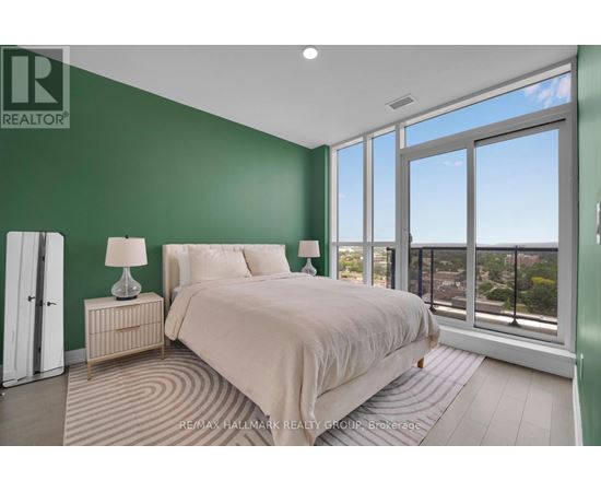 A bedroom with a large bed and a view of the city.
