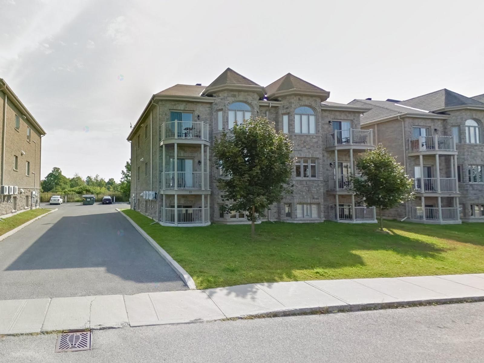 A street view of a residential area with apartment buildings.