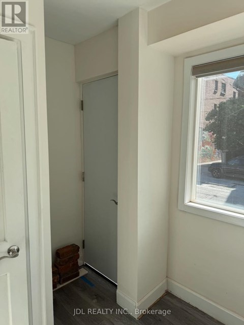 A hallway with a door and a window.