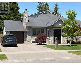 A house with a stone chimney and a car parked in front.