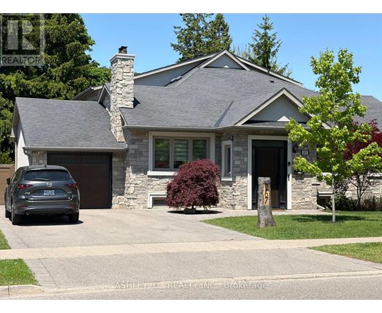 A house with a stone chimney and a car parked in front.