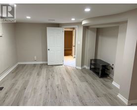 A spacious room with a white door and a black table.