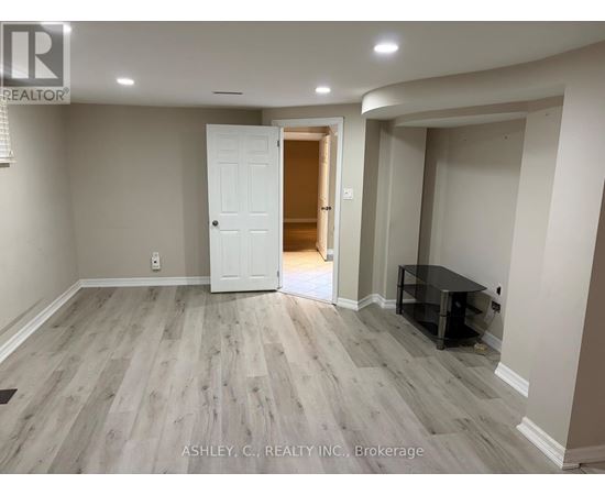 A spacious room with a white door and a black table.