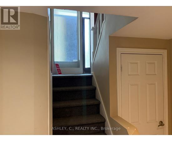 A staircase with a red sign on the railing.
