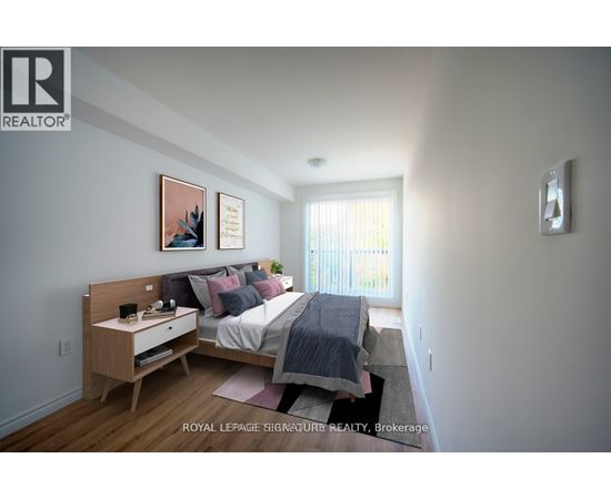 A bedroom with a bed, nightstand, and two pictures on the wall.