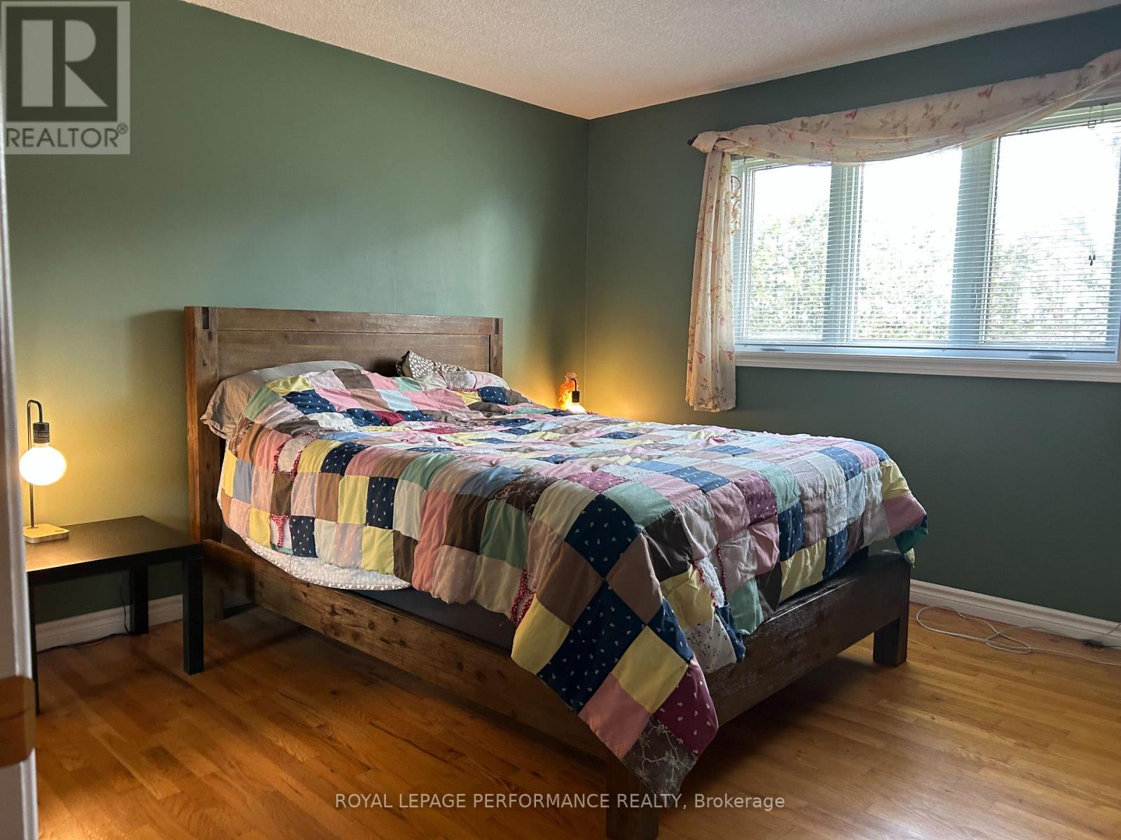 A bedroom with a bed and a window.