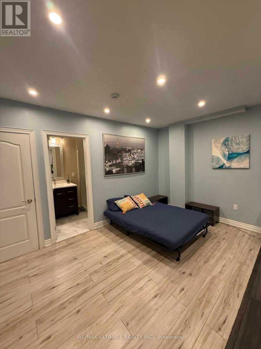 A bedroom with a bed, dresser, and a painting on the wall.