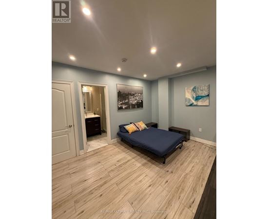 A bedroom with a bed, dresser, and a painting on the wall.