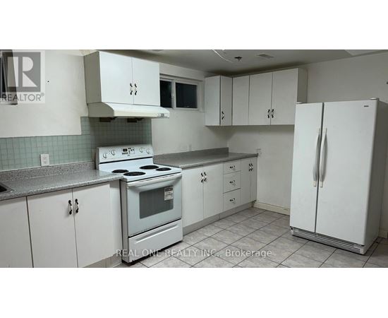 A kitchen with white cabinets and a stove top oven.