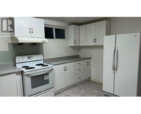 A white kitchen with a stove, oven, and refrigerator.