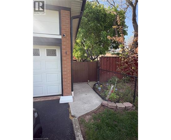 A small garden area with a white garage door.