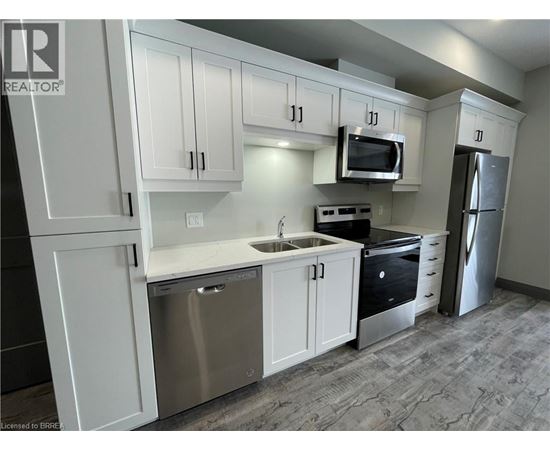 A kitchen with white cabinets and stainless steel appliances.