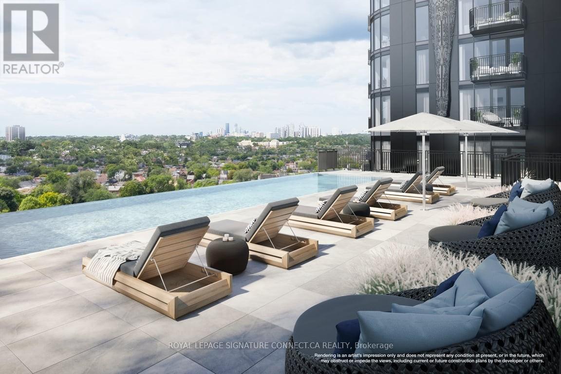 A poolside lounge area with chairs and a view of the city.