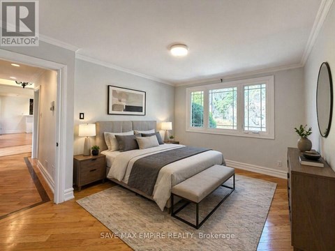 A bedroom with a large bed and a mirror on the wall.