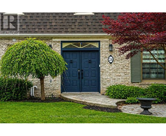 A house with a dark blue front door and a number 24 on the wall.