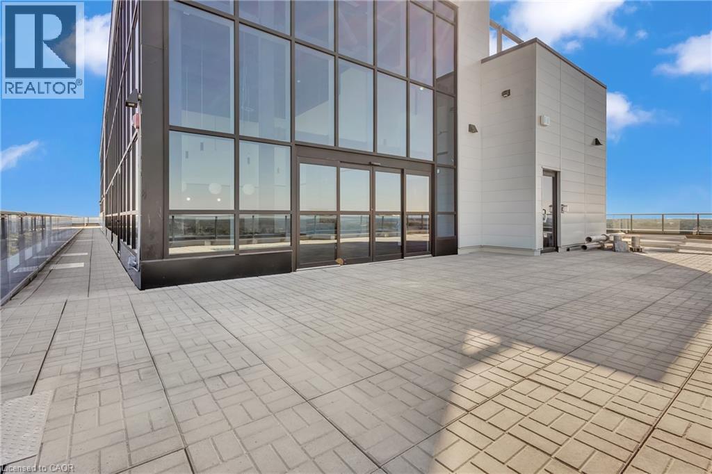 A modern building with a glass facade and a tiled floor.