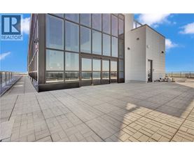 A modern building with a glass facade and a tiled floor.