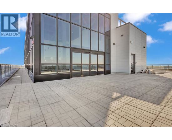 A modern building with a glass facade and a tiled floor.