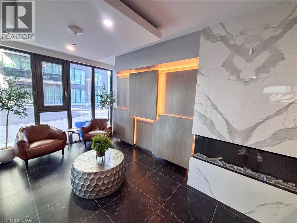 A living room with a fireplace and a large window.