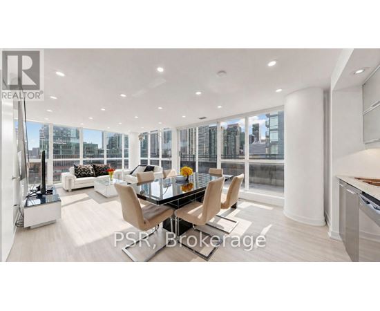 A modern living room with a glass table and chairs.