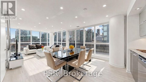 A modern living room with a glass table and chairs.