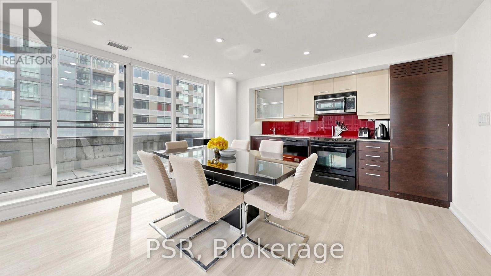 A modern kitchen with a glass table and chairs.
