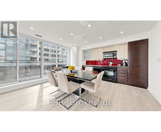 A modern kitchen with a glass table and chairs.