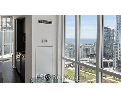A view from a window of a cityscape with buildings and a clear sky.