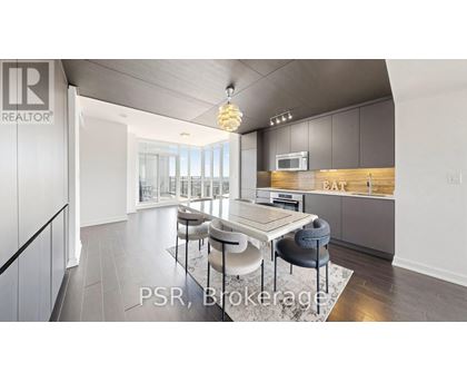A modern kitchen with a dining table and chairs.