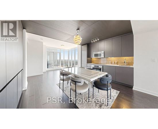 A modern kitchen with a dining table and chairs.