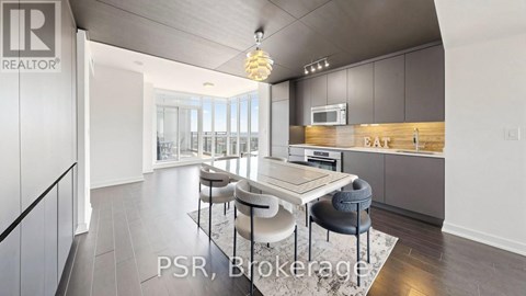A modern kitchen with a dining table and chairs.