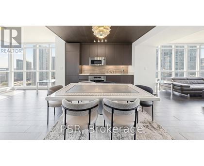 A modern dining room with a large table and chairs.