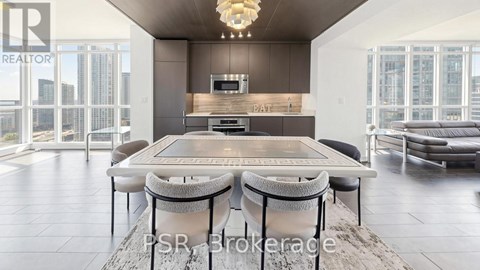 A modern dining room with a large table and chairs.