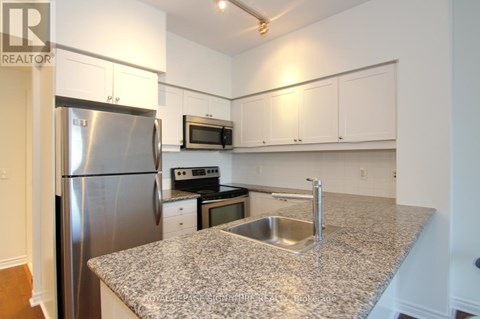 A kitchen with granite countertops and stainless steel appliances.