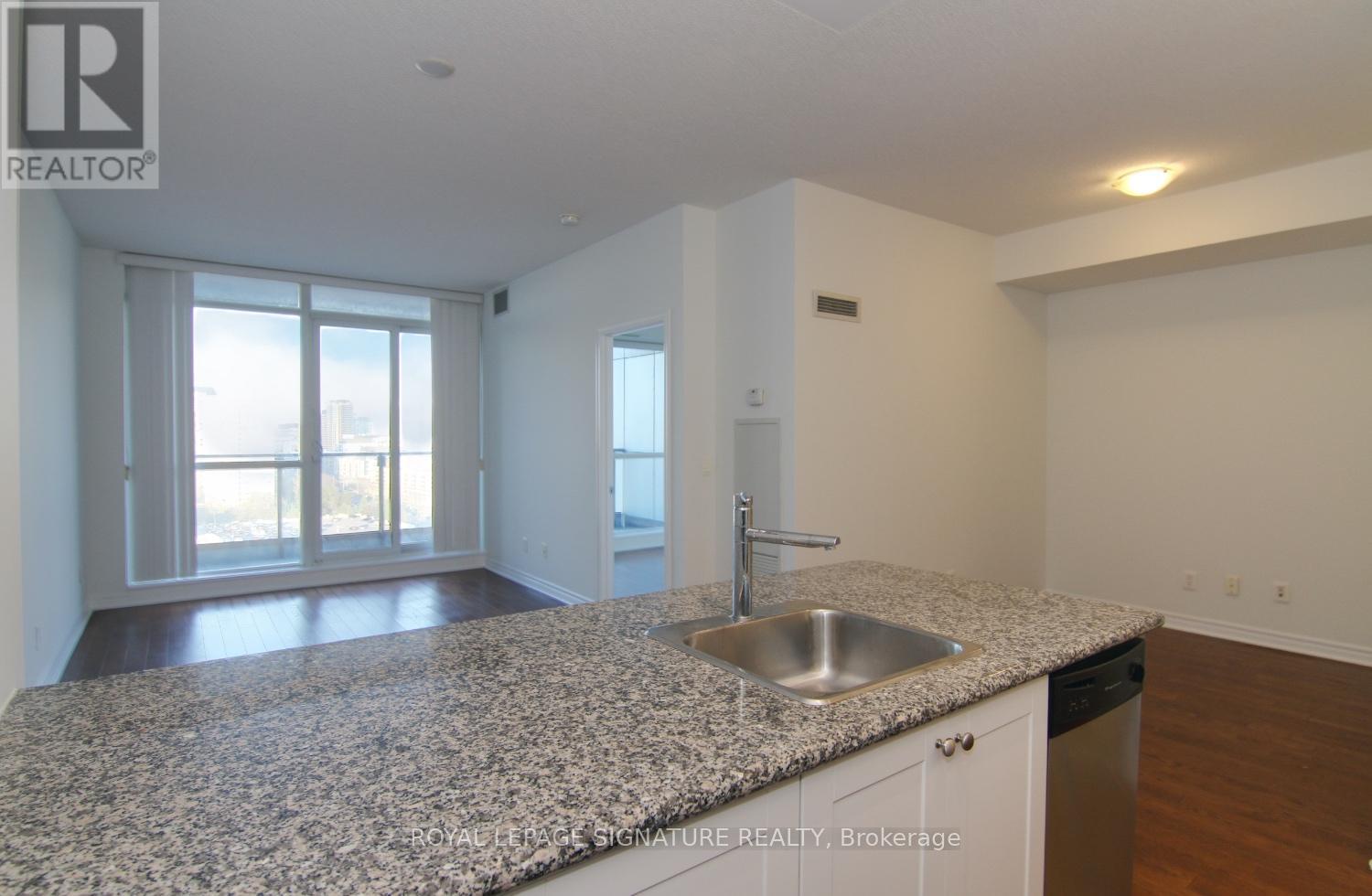 A kitchen with granite countertops and stainless steel appliances.