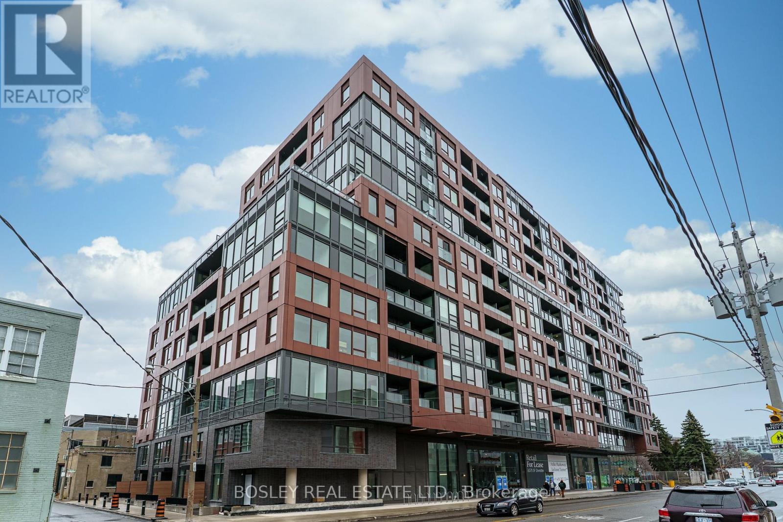 A large red and brown building with the words Bosley Real Estate LTD on the front.