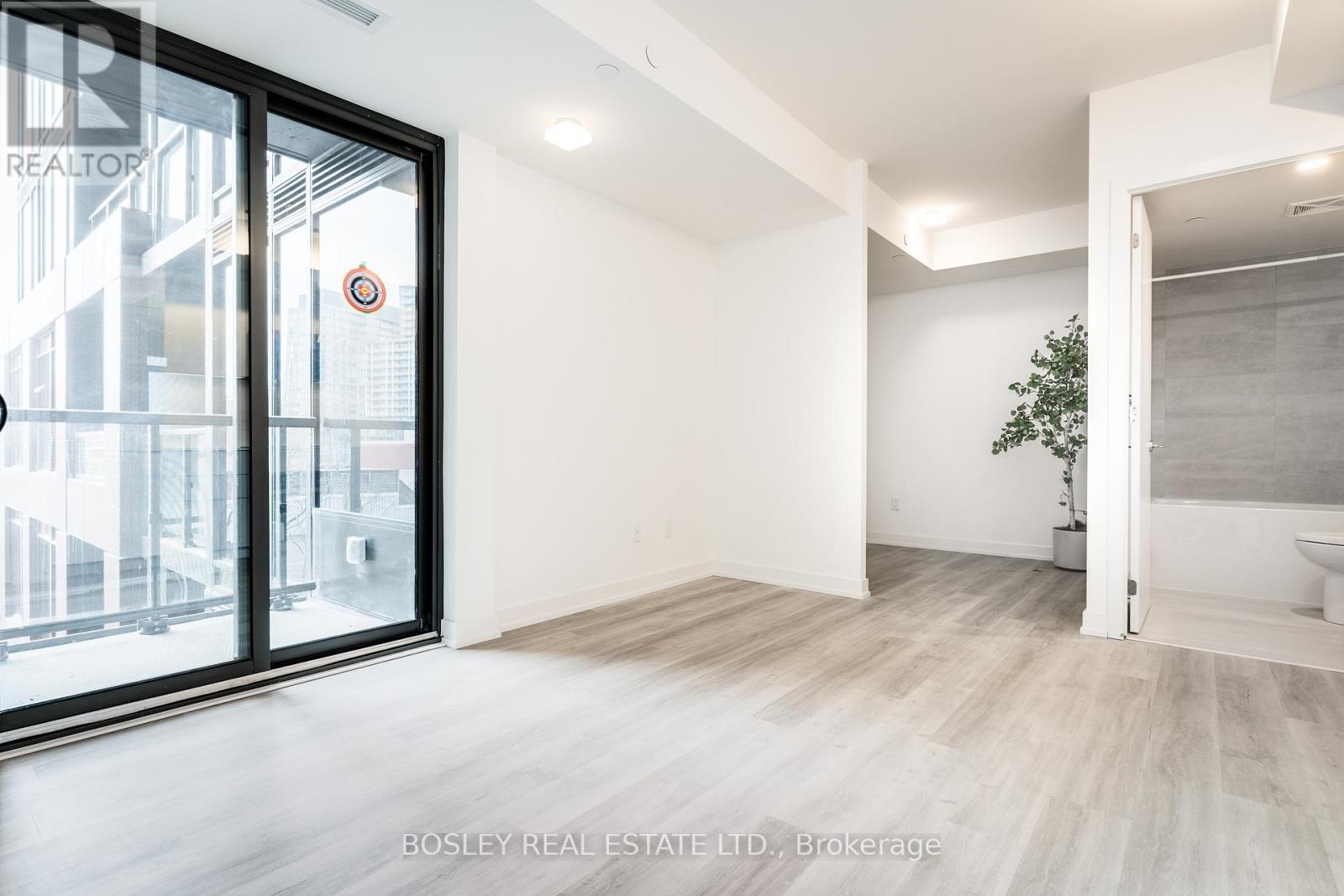 A spacious room with a view of a building outside the window.
