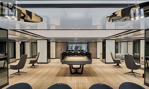 A modern living room with a large table and chairs.