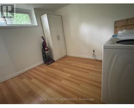 A room with a washing machine and a vacuum cleaner.
