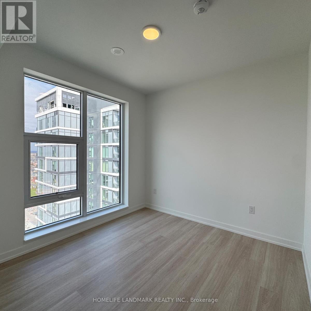 A room with a large window overlooking a building.