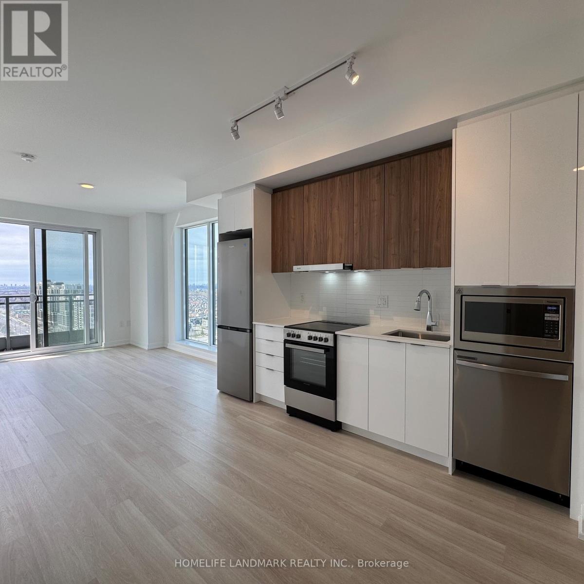 A modern kitchen with wooden cabinets and stainless steel appliances.
