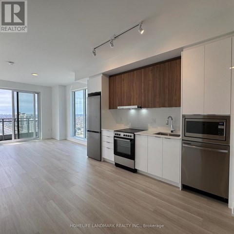A modern kitchen with wooden cabinets and stainless steel appliances.