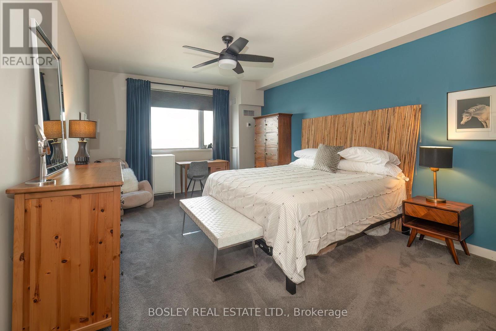 A bedroom with a bed, nightstand, and a dresser.