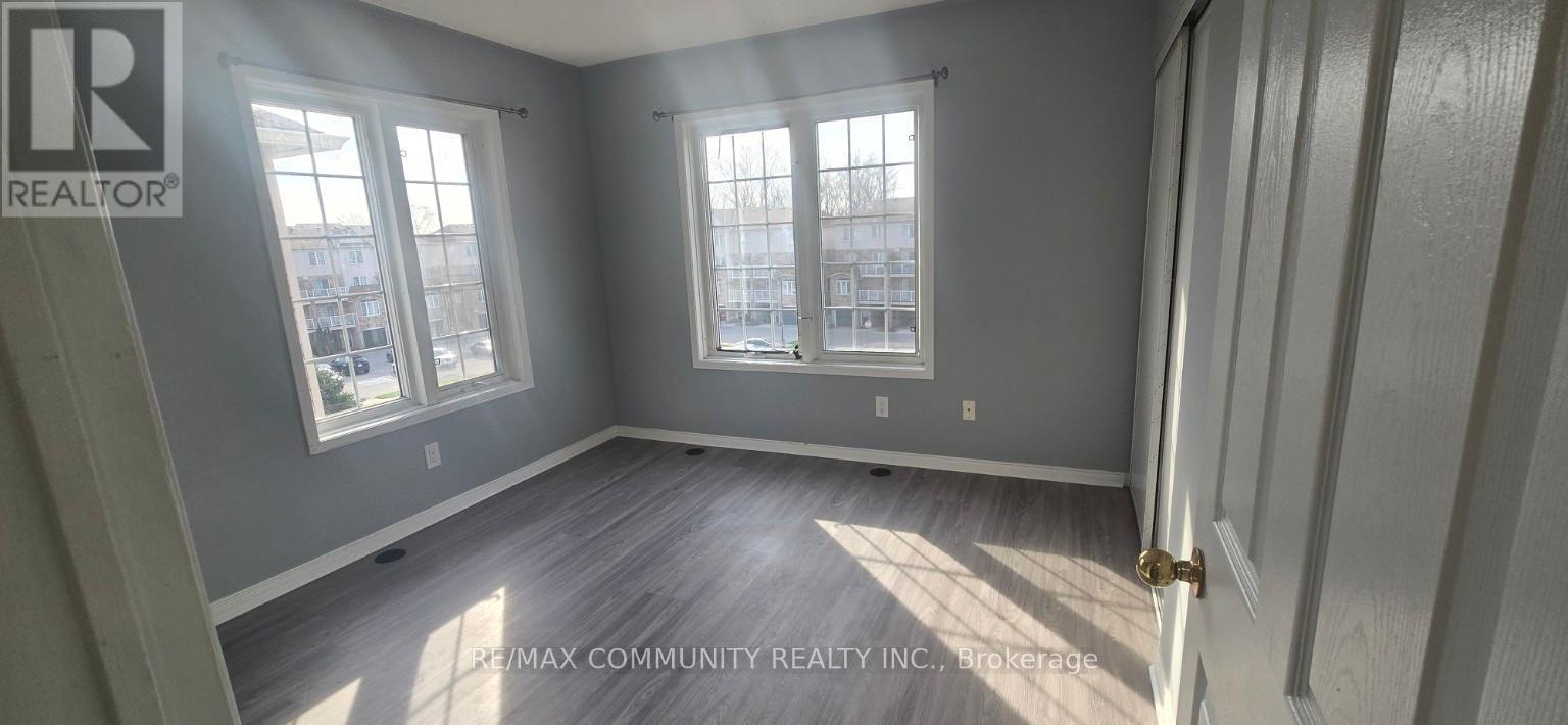 A room with a door and two windows.