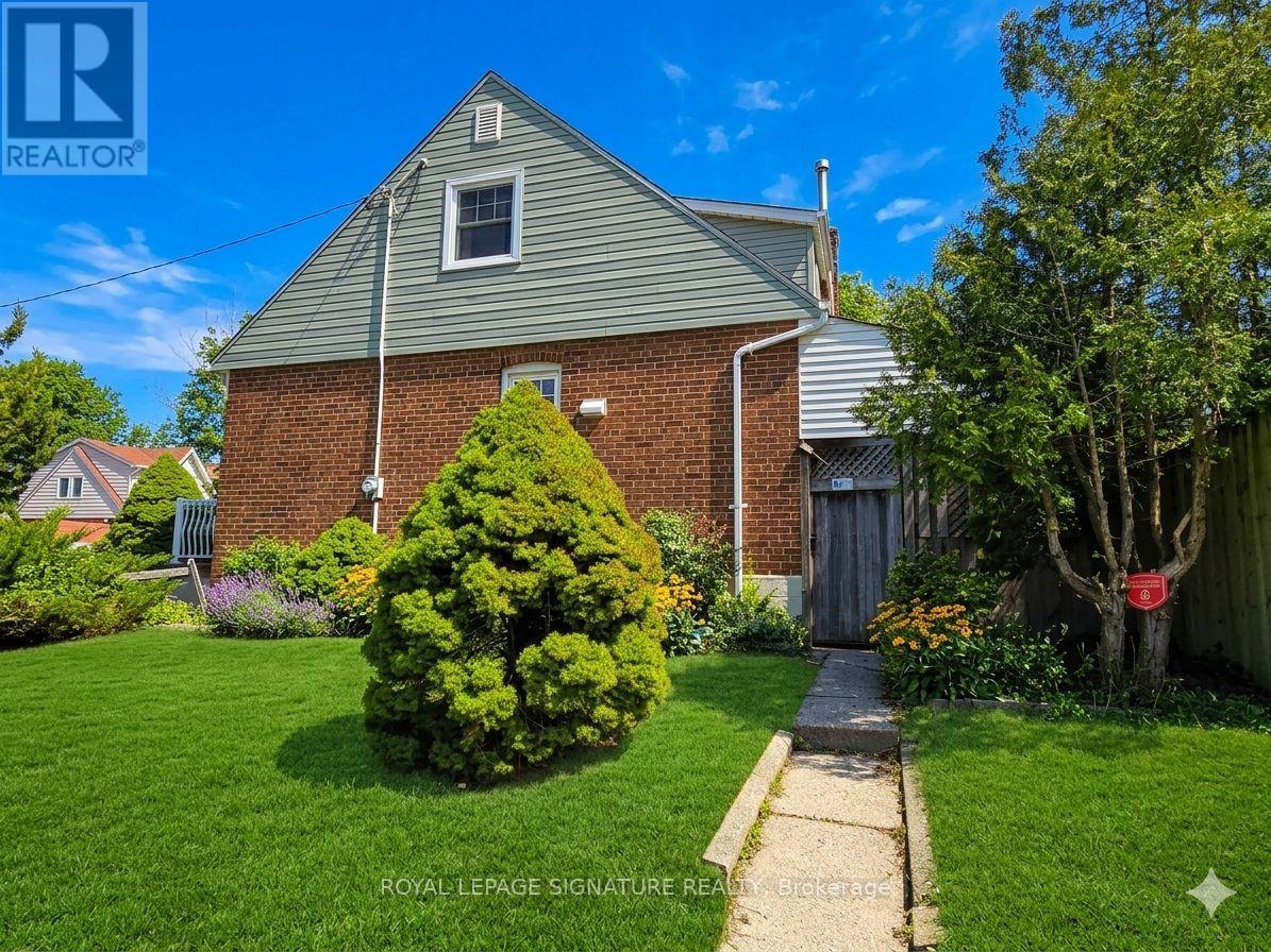 A house with a well-maintained lawn and a Royal LePage sign in the foreground.