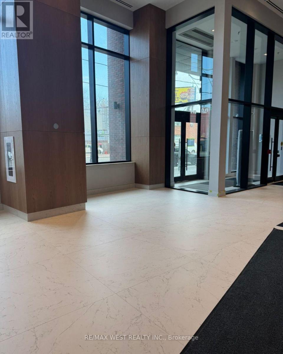 A hallway with a black carpet and white marble flooring.