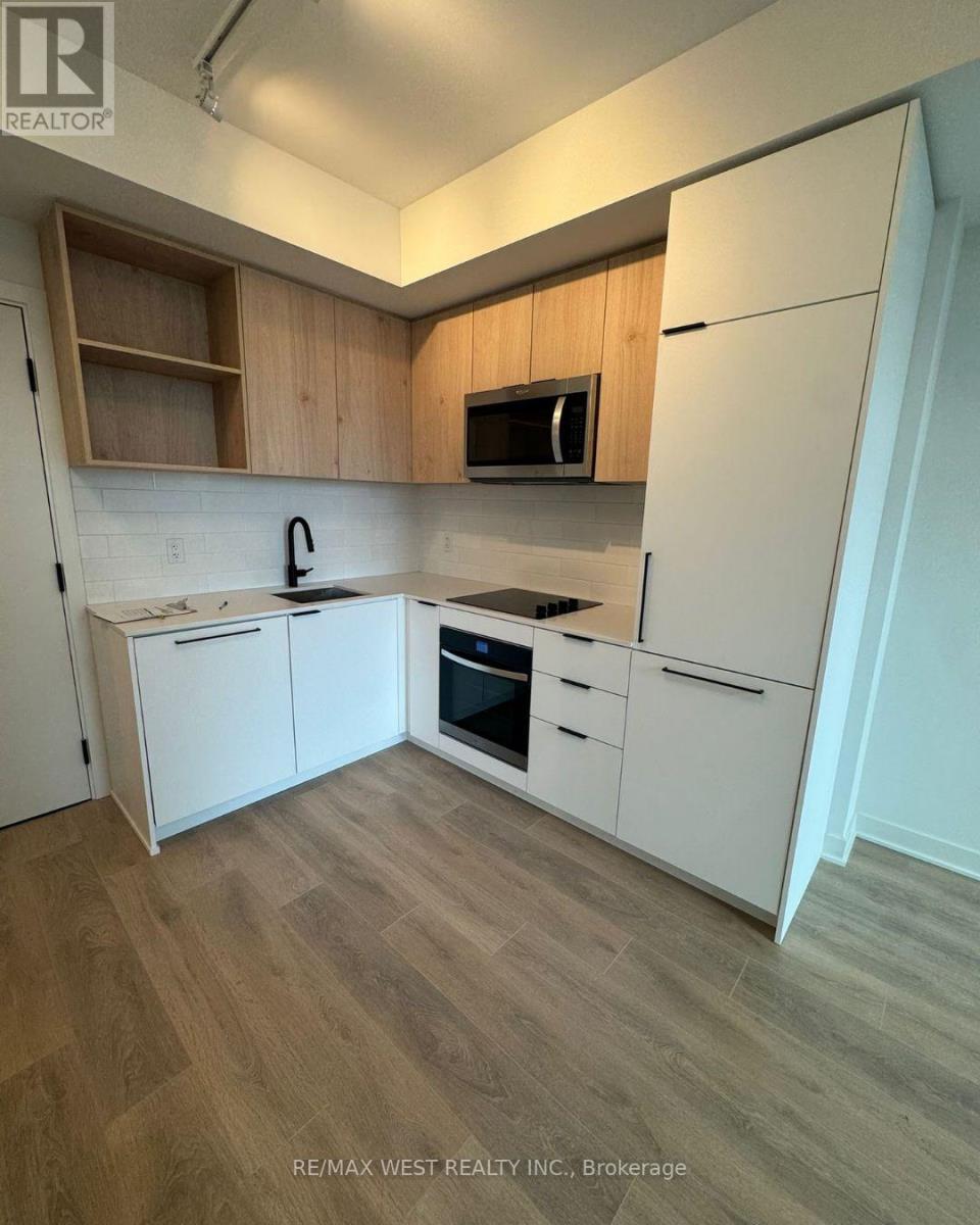 A kitchen with white appliances and wooden cabinets.