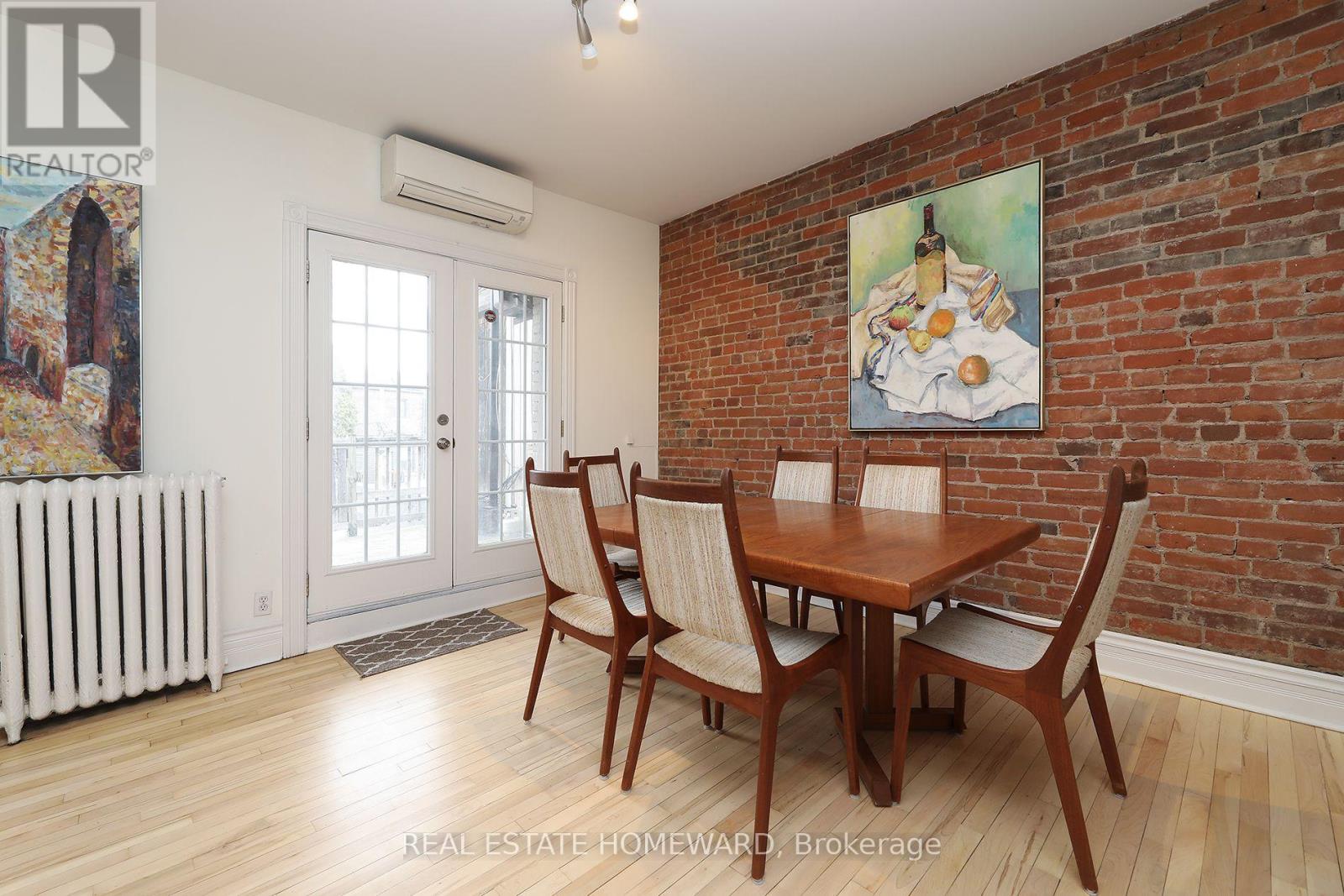 A dining room with a wooden table and chairs.